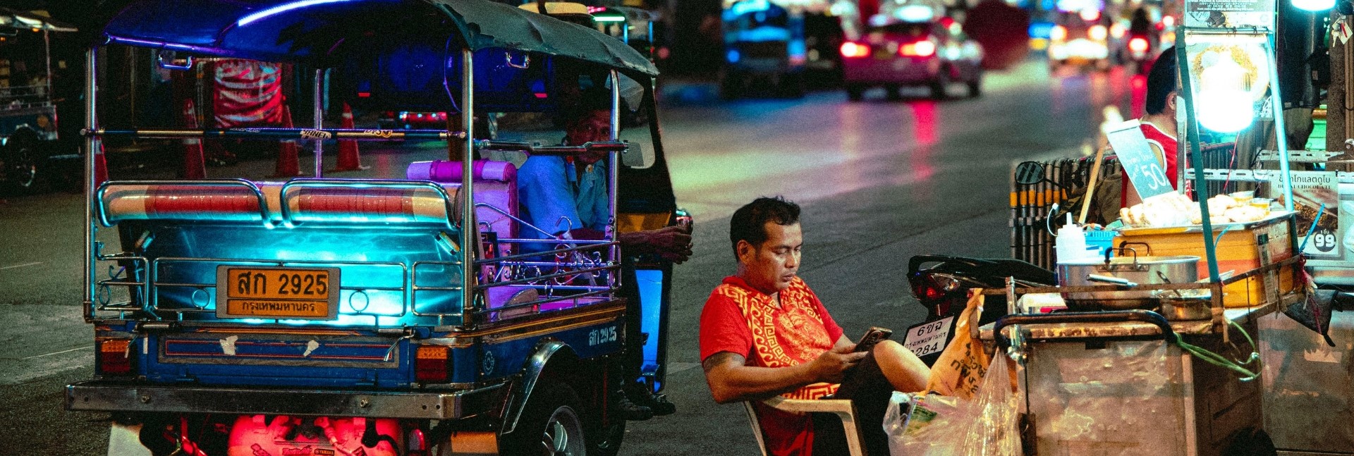 Cyclists enjoying Thai street food in Bangkok's old town on the Bike and Bites food tour